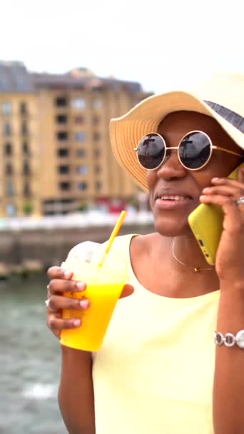 Black Ethnic Woman Drinking Orange Juice Texting Phone Tourist Enjoying — Stock Video