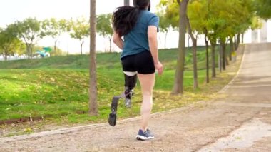 Dışarıda koşan protez bacaklı engelli bir adamın yakın plan görüntüsü.