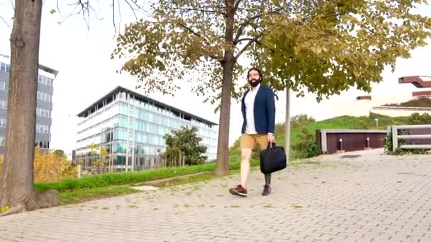 Video with copy space of a businessman with amputee leg walking along an urban park