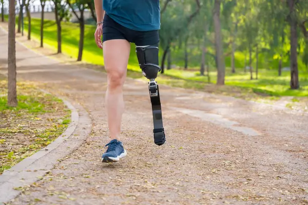 stock image Cropped photo of an unrecognizable runner with prosthetic leg training in a park