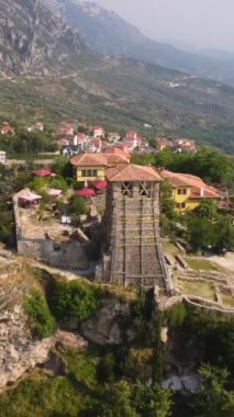 Kruje Kalesi 'nin ve Kruje Kulesi' nin içindeki kalesinin ve arka planda dağların olduğu müzenin insansız hava aracı görüntüsü. Arnavutluk