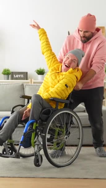自宅で手を挙げることを祝う車椅子と友人の幸せな障害者 — ストック動画