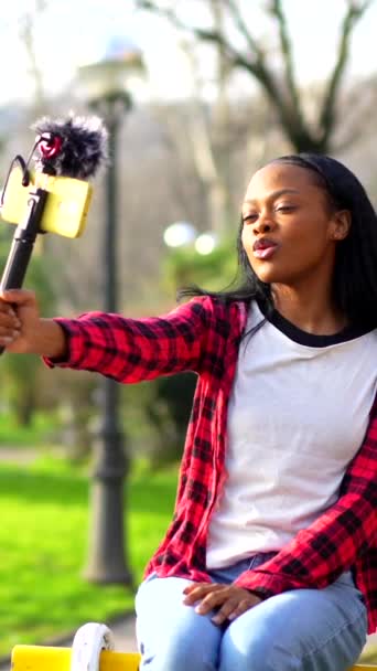 Young African Vlogger Records Video Mobile Park — Stock Video