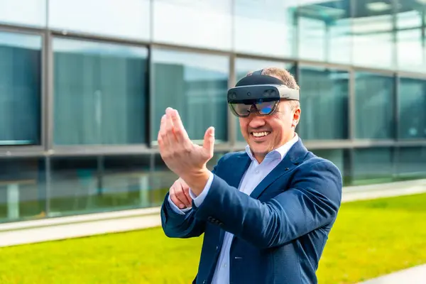 Happy adult caucasian businessman smiling while wearing mixed reality glasses outside a financial building