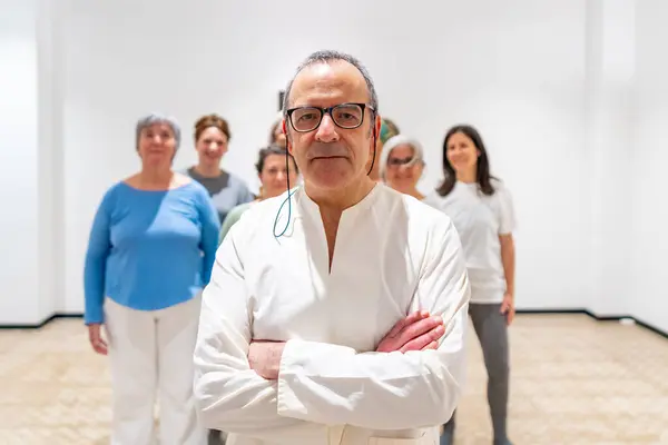 Group portrait of Qi Gong teacher and the class group in the background