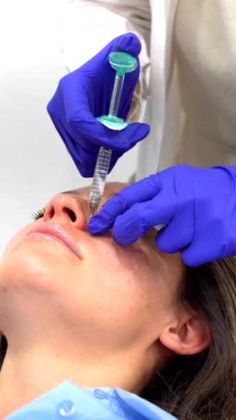 Doctor Cosmetologist Makes Rejuvenating Facial Injections Procedure Tightening Smoothing Wrinkles — Stock Video