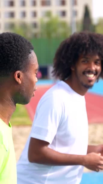 Side View Two Smiling African Young Friends Stretching Warming Running — Stock Video