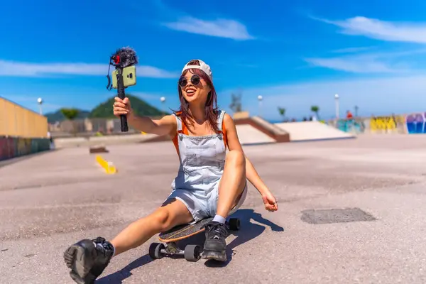 stock image Smiling chinese female vlogger filming at skateboard park in summer