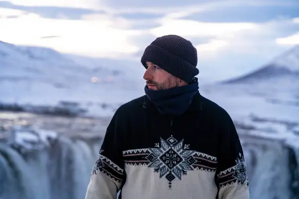 stock image Portrait of an adventurous hiker at the frozen Godafoss waterfall in winter, Iceland