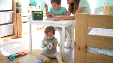 Mutlu bekar anne ve oğullar evdeki yatak odasında oturuyorlar.