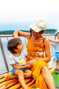 Mother and son tourists on a boat on Lake Titisee in the Black Forest, Germany clipart