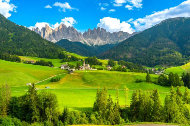 Santa Maddalena Köyü 'nün önündeki vadiyi çevreleyen yeşil çayırlar, Dolomite' ların göz kamaştırıcı dağ grubu tarafından çevrelenmiş.
