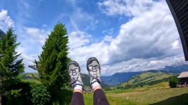 İtalya 'daki Dolomites dağlarında salıncakta sallanan bir kadının ayakları.