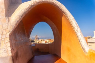 Scenic view of sagrada familia and barcelona cityscape through an architectural arch, capturing the essence of catalan modernism clipart