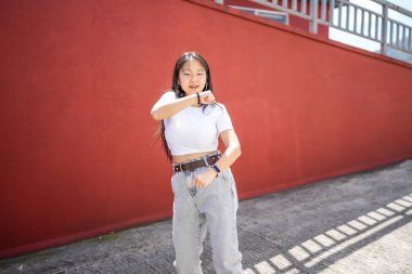 K-pop bayan Asyalı genç dansçı sokaklarda gösteri yapıyor.