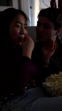 Genç, çok ırklı bir çift sıcak bir gece geçiriyorlar, patlamış mısır paylaşıyorlar ve kanepede sevgi dolu anlar yaşıyorlar.