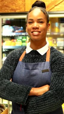 Soğutulmuş raflardan organik bakkaliyeleri dikkatlice seçen, sağlıklı beslenme odaklı mağazalarda sağlıklı besleyici ürünlere göz atan sağlıklı bir kadın.