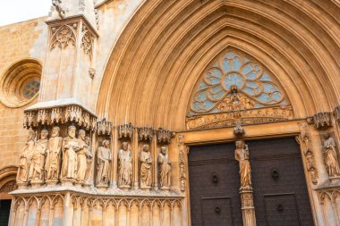 Tarragona Katedrali 'nin zengin ana girişini süsleyen aziz heykelleri Gotik ve Romansı mimarinin çarpıcı bir örneği.
