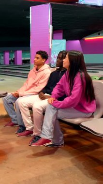 Bowling hocası öğrencilerine bowling topu fırlatmak için doğru duruşu ve hareketleri gösteriyor.