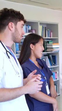 Doktorlar ve hemşireler hastane ortamında hasta bakımı hakkında fikir alışverişinde bulunuyorlar.