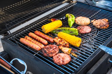 Cızırdayan sosisler, sulu hamburger köfteleri, taze tavuk ve ızgarada ızgara yapan mısır koçanları, ağız sulandırma ziyafeti yaratıyor.
