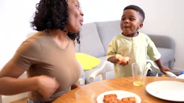 Afro-Amerikan annesini sevmek, sabah yemeğini neşeli çocuklarla paylaşmak, kahvaltı masasında kaynaşırken sağlıklı yemek ve sohbetin tadını çıkarmak.