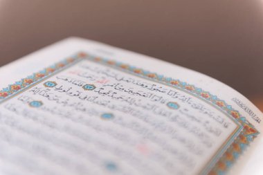 Sarajevo, Bosnia and Herzegovina, 20th february 2023; Muslim beads and Koran or Qoran on wooden table. Islamic religion concept.