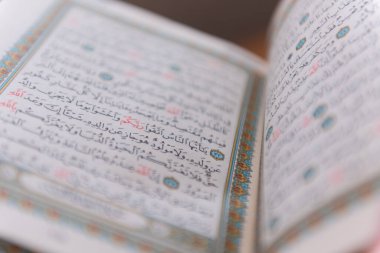 Sarajevo, Bosnia and Herzegovina, 20th february 2023; Muslim beads and Koran or Qoran on wooden table. Islamic religion concept.