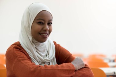 Young female african student  spending her time during lecture inside classroom  in an international university