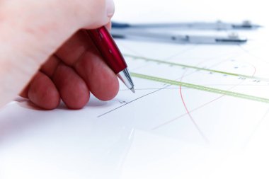 Professional architect working at his desk, measuring and estimating the building project