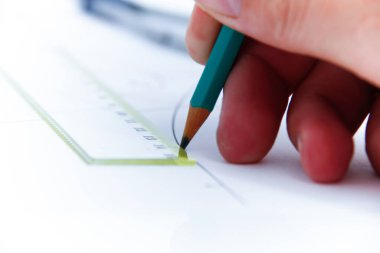 Professional architect working at his desk, measuring and estimating the building project