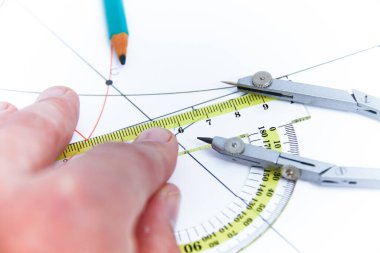 Professional architect working at his desk, measuring and estimating the building project