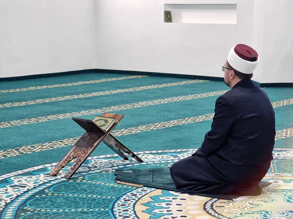 Islam, religion and prayer of a muslim leader or imam at mosque in ramadan for spiritual faith