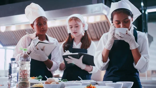 stock image Group of schoolgirls having fun learning to cook. Female students in a cooking class.