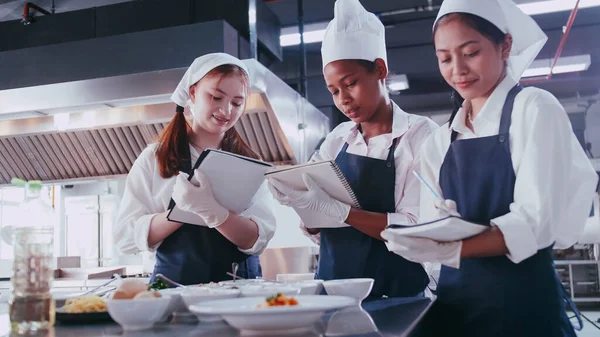 stock image Group of schoolgirls having fun learning to cook. Female students in a cooking class.