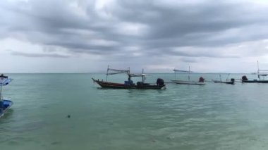 Fishing boats in the sea at the pier in cloudy cloudy weather. The Gulf of Thailand is part of the South China Sea, washing the southwestern coast of Thailand. High quality 4k footage