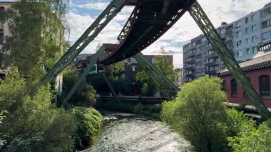Wuppertal Askılık Demiryolu 'nun üst geçidinde raylı vagon hareket ediyor. Wuppertal, Kuzey Ren Vestfalya 'daki toplu taşıma metropolü, Almanya 29 Temmuz 2024. Yüksek kalite 4k görüntü