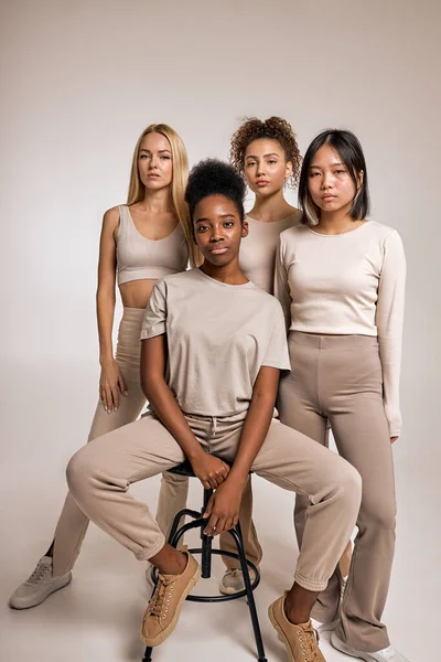 group of confident women with different kind of skin, ethnicity posing together. Diverse beauty and body positivity, tolerance, friendship concept. copy space. isolated in studio, portrait