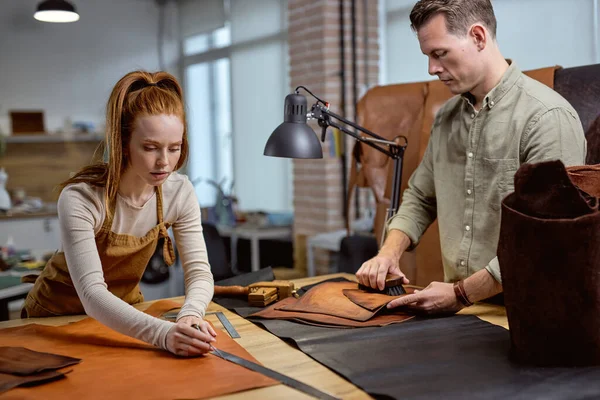 young ambitious people crafting high-quality leather products, close up portrait,