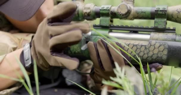 女兵躺在地上 坐在草地上 伪装备战 在农村装武器 — 图库视频影像