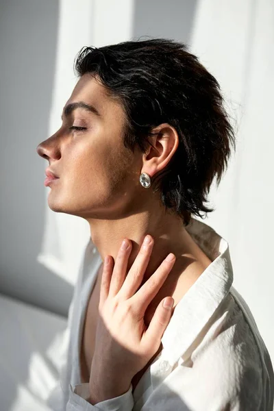 young attractive glamour elegant man takes care of his sceen, body, neck face. close up side view photo. sexuality,love