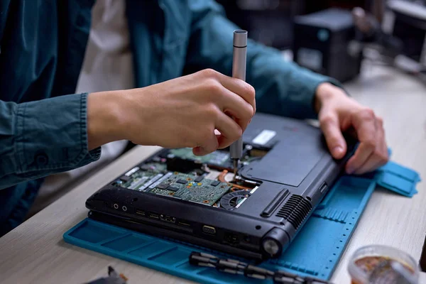 stock image Closeup of unrecognizable engineer technician hands repairing faulty on laptop computer in electric device technology service, male using special tools. Maintenance notebook support service engineer