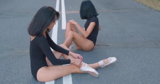 Όμορφη Νεαρή Λευκή Μπαλαρίνα Κάθεται Στο Δρόμο Δένει Pointe Παπούτσια — Αρχείο Βίντεο