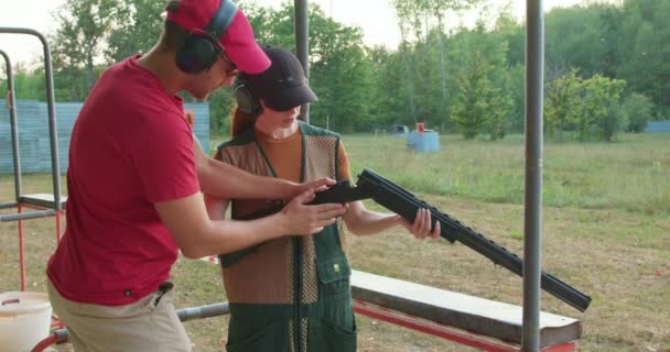 Young Couple Wearing Protective Safety Goggles Headsets Caps Sporting Clays — Stock Video