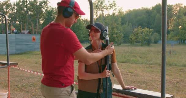 Handsome Caucasian Man Headset Confidently Teaching Woman Use Rifle Weapon — Stock Video