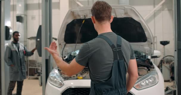 Farklı Uluslararası Oto Tamircisi Garajda Araba Kaldırma Makinesinin Altında Çalışan — Stok video