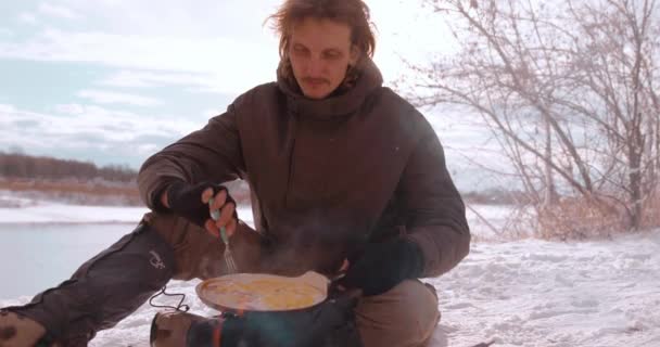 Fair Haired Man Tourist Sitting Snowy Ground Having Snack Bank — Stock Video