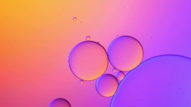 pastel color of oil drop floating on the water. The art of water surface for your products display and artwork design with copy space. holiday light background. holiday postcard background.