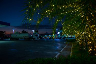 Mahasakham, Thailand - November 30,2021: PTT gasstation. It is decorated with beautiful lights when the sun sets. clipart