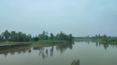 Aerial view of a river in daylight with blue sky. Dinajpur, Bangladesh.